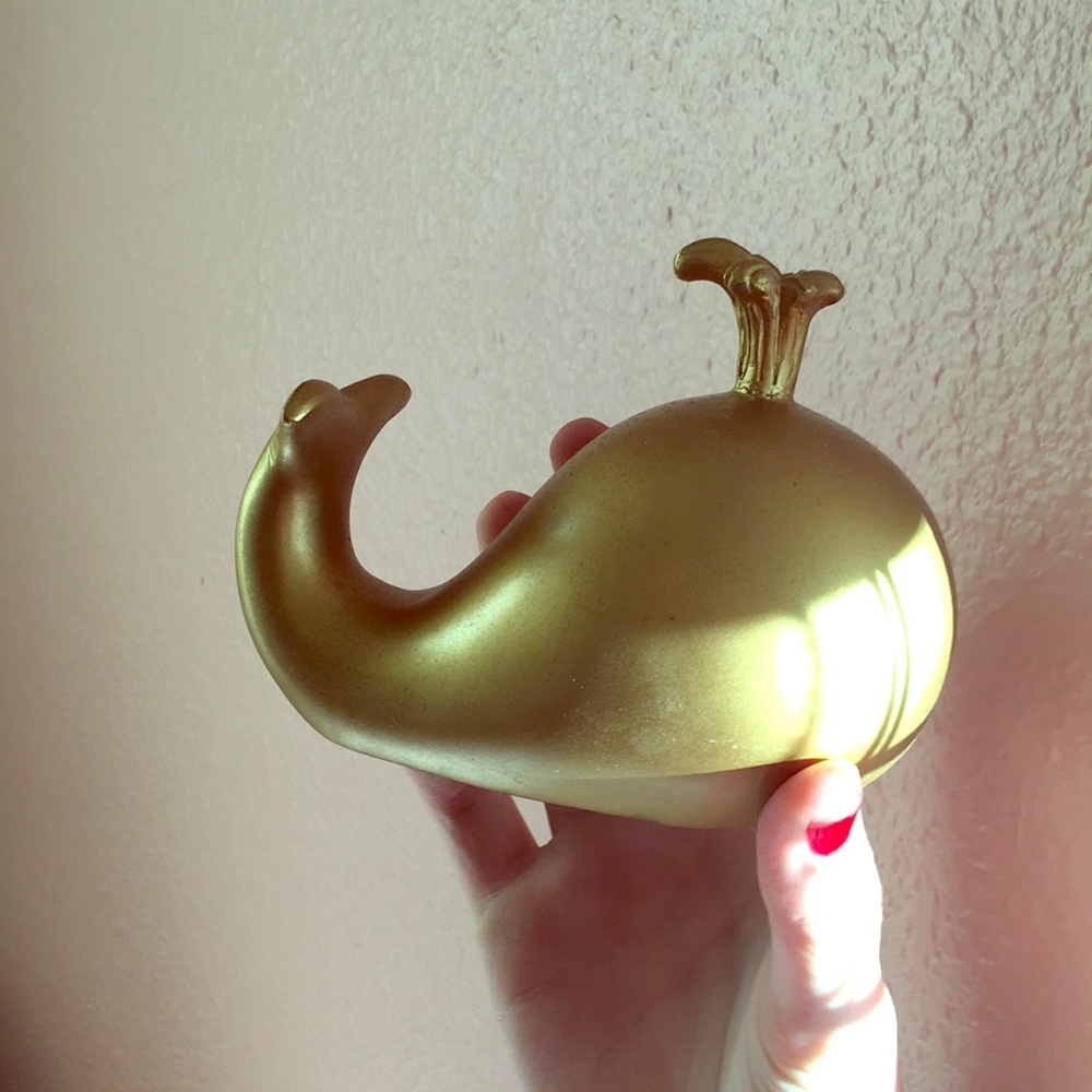 A gold decorative whale